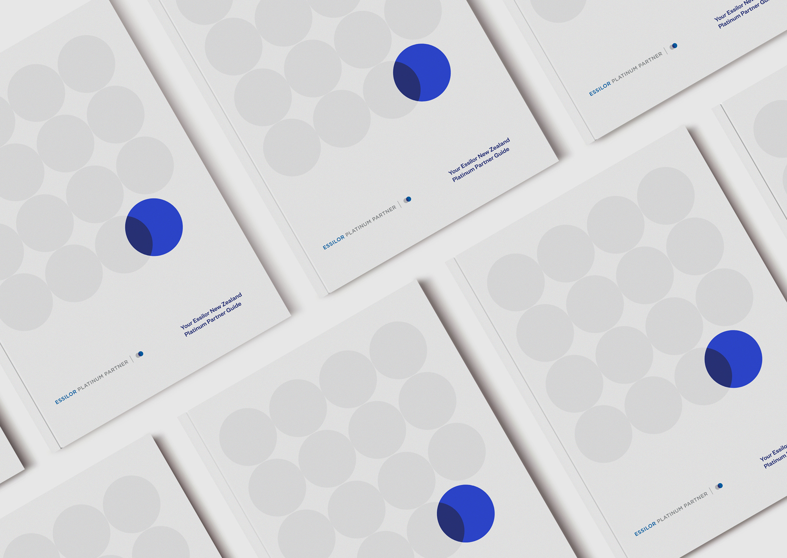 Essilor NZ Platinum Partners brochure – multiple front covers featuring series of circles and cobalt blue overlap