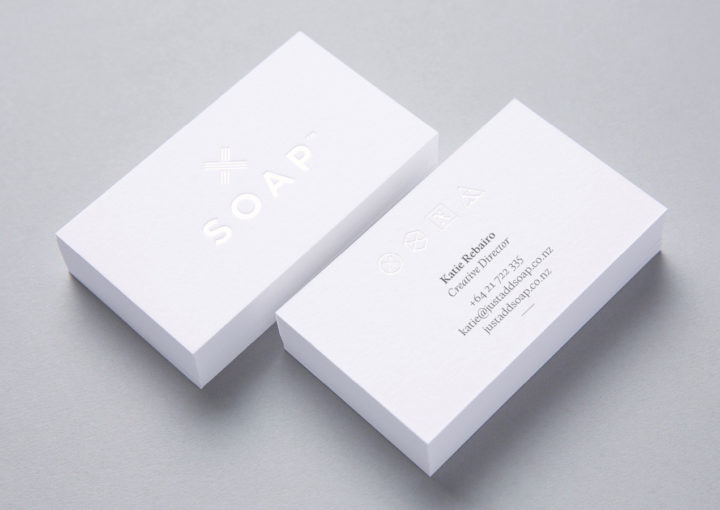 SOAP™ branding – close up of embossed white on white foil business cards