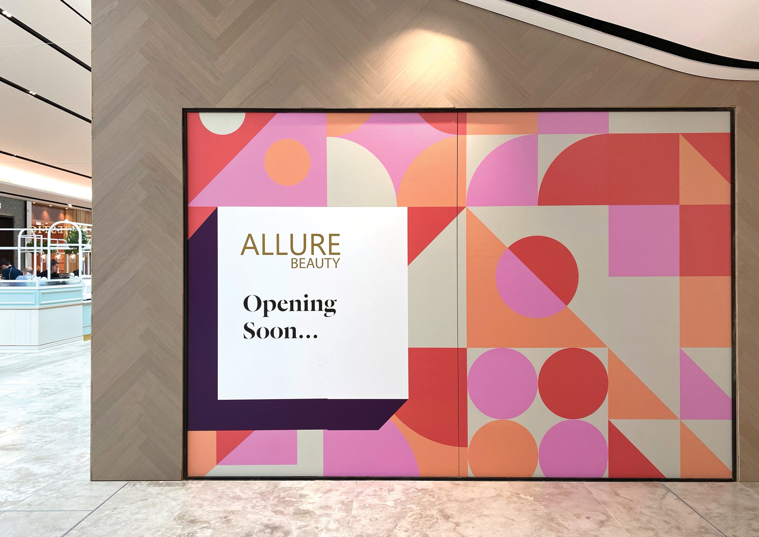 Large scale retail graphics at Sylvia Park Level 1 Launch featuring an eye-catching pink and peach geometric pattern